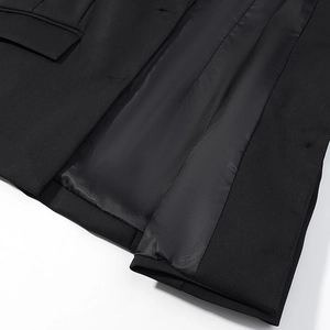 Detail of black jacket showing smooth satin lining and high-quality hem craftsmanship
