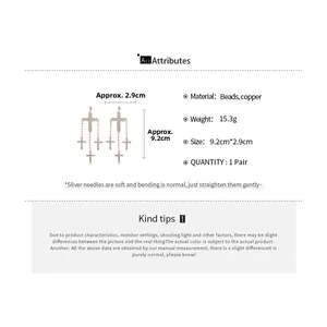 Detailed product specs of cross tassel earrings showing dimensions of 9.2cm by 2.9cm