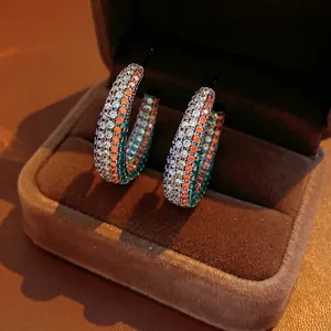 Vintage-style C-shape earrings with colorful cubic zirconia in a jewelry box