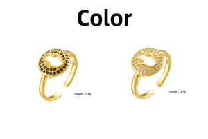 Detail of gold-plated Hamsa Hand rings with black and white cubic zirconia accents
