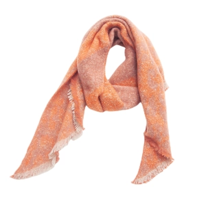 Detail of soft knit plaid scarf with fringe edges in orange and beige tones