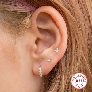 Detail showing 925 sterling silver earrings set with flower and lightning studs