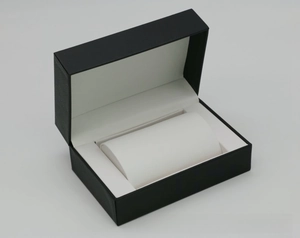 Detail of the flip-top black PU leather watch box with white velvet lining and soft pillow