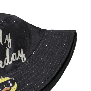 Detailed close-up view of a Happy Birthday printed black bucket hat fabric and stitching