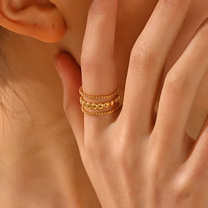 Three-layer twisted 18K gold plated stainless steel ring set worn on model hand