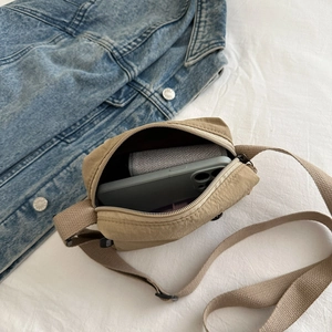 Piccola borsa a tracolla in nylon kaki che mostra lo spazio per telefono e portafoglio