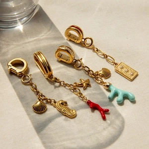 Golden stainless steel ocean pendants featuring seahorse, starfish and coral charms