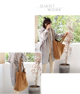 Detailed view of brown canvas tote bag with spacious open design and dual shoulder straps