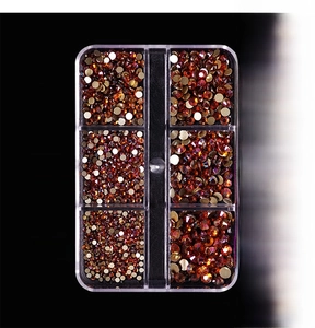 Macro view of amber gold glass rhinestones in a 6-grid box with ss4-ss16 sizes