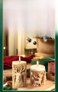 Detail of 3D reindeer relief patterns on cylindrical Christmas scented candles
