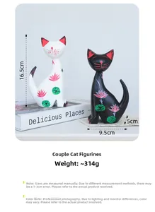 Detail view of hand-painted Nordic cat figurines with pink lotus floral patterns