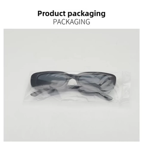 Detailed shot of retro small frame sunglasses in protective clear plastic packaging