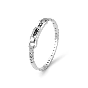 Detail of silver stainless steel bangle with inlaid crystals and geometric hollow design