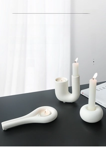 Three-piece set of matte white ceramic candle holders in modern minimalist shapes