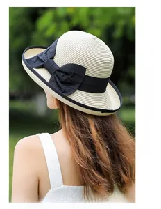Close-up of a vintage straw hat with delicate weaving and a large black ribbon bow