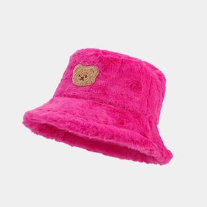 Detail of rose pink plush bucket hat featuring fuzzy faux fur texture and bear embroidery