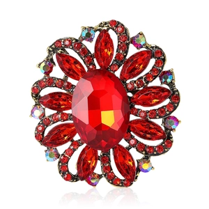 Vintage floral brooch with red rhinestones and AB crystals on bronze metal base