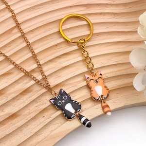 Handmade kitten charms set with moving tails on gold necklace and keychain