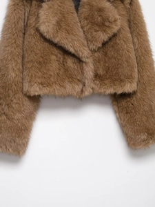 Close-up of brown faux fur lining and plush texture on short fashion biker jacket