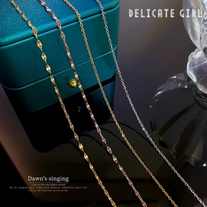 Golden and silver 304 stainless steel necklaces displayed on a green leather jewelry box