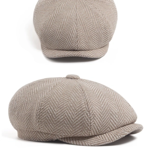 Detailed view of the classic light brown herringbone tweed pattern on a newsboy cap