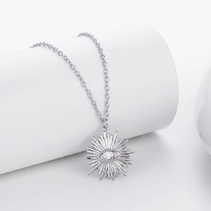Macro detail of S925 sterling silver Evil Eye necklace with radiant sun pattern and crystals