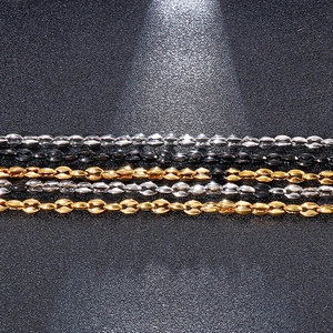 Close-up showing a row of oval links in silver, black, and gold finish stainless steel chain