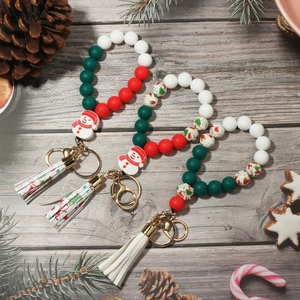 Close-up of Christmas silicone bead bracelets with snowman charms and festive tassels