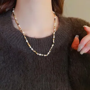 Maillard style freshwater pearl and agate beaded necklace on a brown sweater background