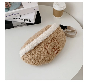 Close-up of brown plush waist bag with cute cartoon bear and lamb wool texture