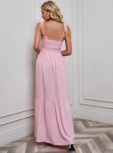 Detail of pink smocked bodice and thin straps on a long summer beach maxi dress