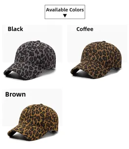 Detailed view of three leopard print baseball caps with distressed ripped brim details