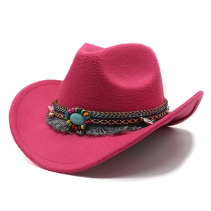 Detail of ethnic western cowboy hat with colorful beaded band and turquoise stone