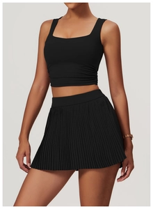 Detail view of the drawstring side seam on a tight black yoga tank top with ruched texture