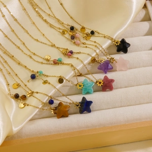 Detailed display of assorted colorful star-shaped gemstone pendants on gold chains