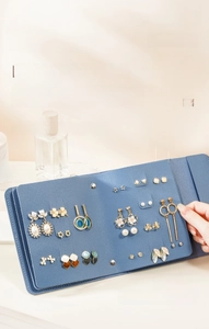Light blue PU leather jewelry book organizer showing capacity for 42 pairs of earrings
