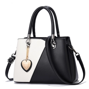 Minimalist black and white patchwork leather handbag with silver heart pendant