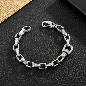 Industrial silver chain bracelet with large lobster clasp on black leather background