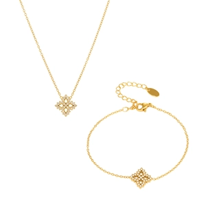 Elegantes vergoldetes Schneeflocken Schmuckset mit Zirkonia Steinen auf weißem Grund