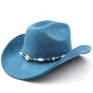 Detailed texture of blue suede cowboy hat featuring bohemian shell and bead hatband