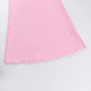 Detailed close-up of pink dress hem featuring elegant wavy lettuce edge stitching