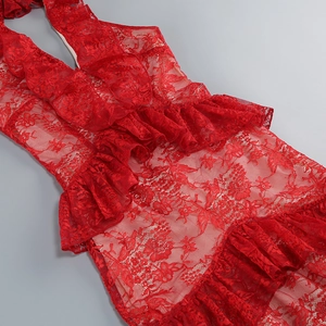 Detailed view of red floral lace fabric and layered ruffle trim on backless summer dress