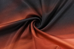 Close-up of ribbed knit fabric with black, brown, and orange gradient color texture