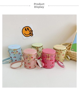 Detailed view of five colorful cherry print mini bucket bags with flower zipper pulls