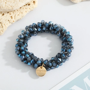 Deep blue crystal bead elastic hair tie with handmade gold charm on coral decor