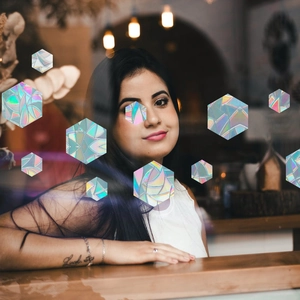 Rainbow prism static glass film showing colorful light effects on a woman's arm