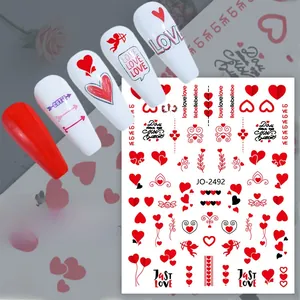 Detail view of Valentine nail stickers with red hearts, Cupid motifs and Love lettering
