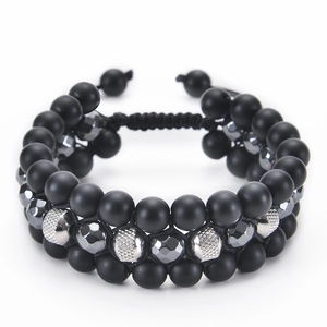 Detail of 8mm volcanic stone triple braided bracelet with stainless steel beads