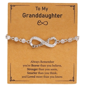 Detail of silver infinity bracelet with Granddaughter engraving and zircon stones