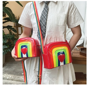Comparison view showing small and large rainbow crossbody bags with heart patches